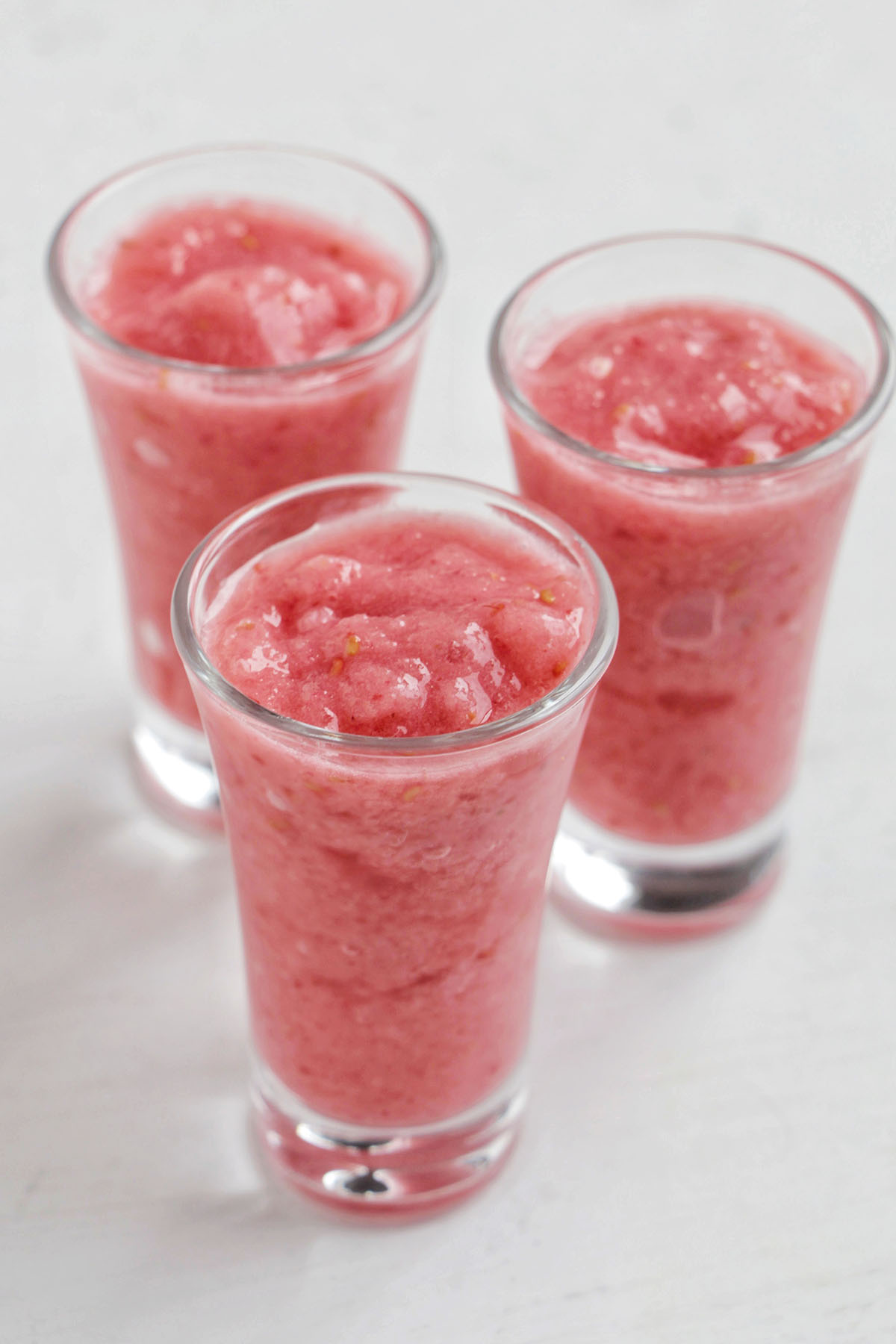 three blended raspberry daiquiri shots.