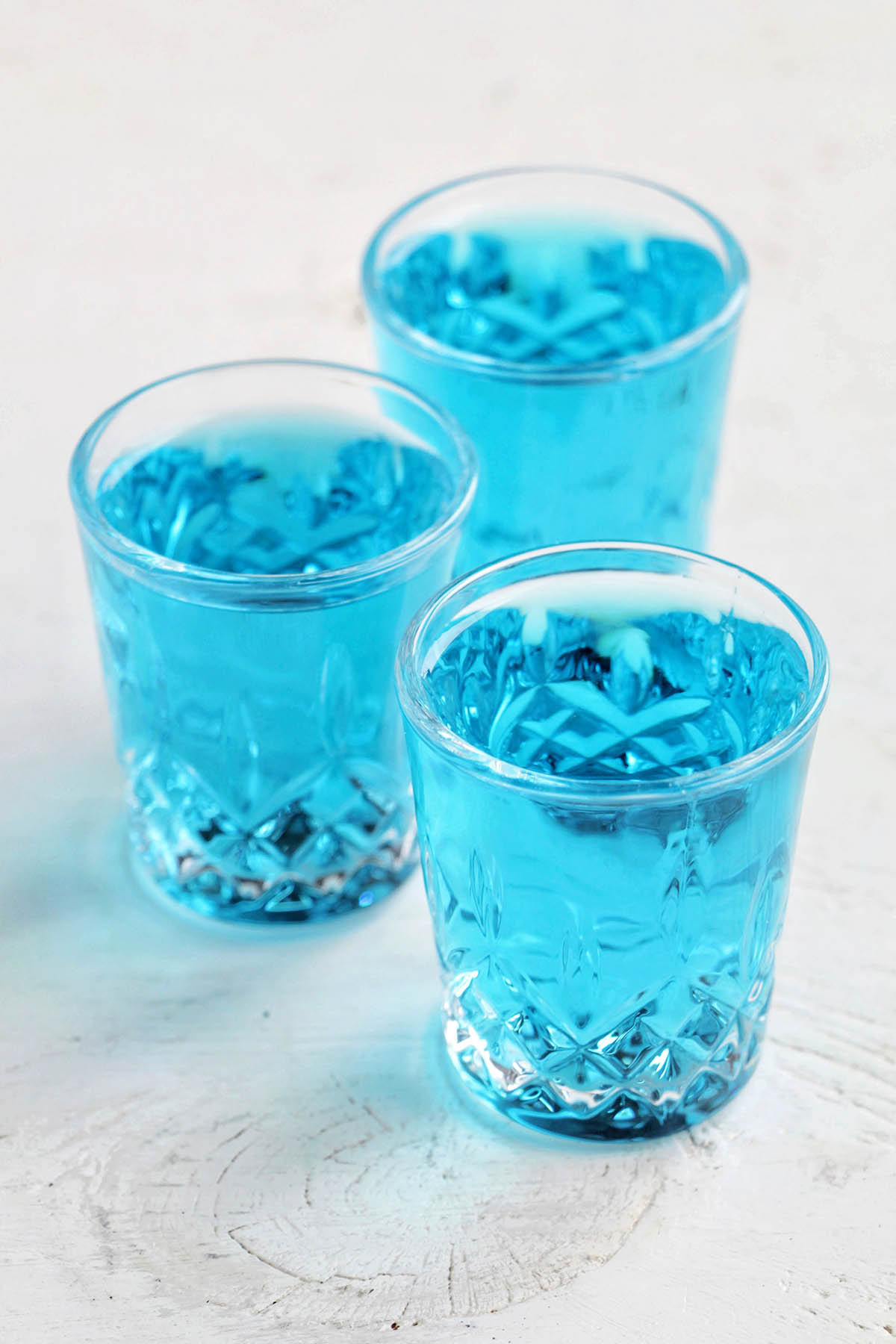 three blue daphne martini shots.