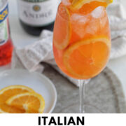 Italian Aperol spritz cocktail with orange garnishes.