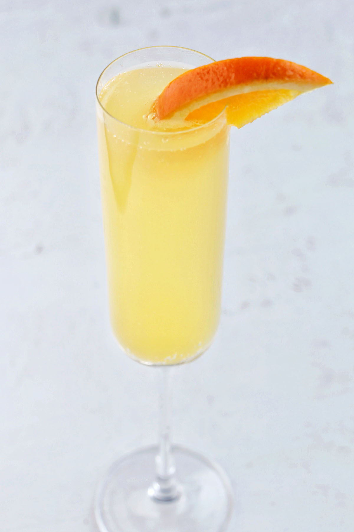 mimosa with orange garnish.