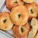 plain bagels on sheet tray.