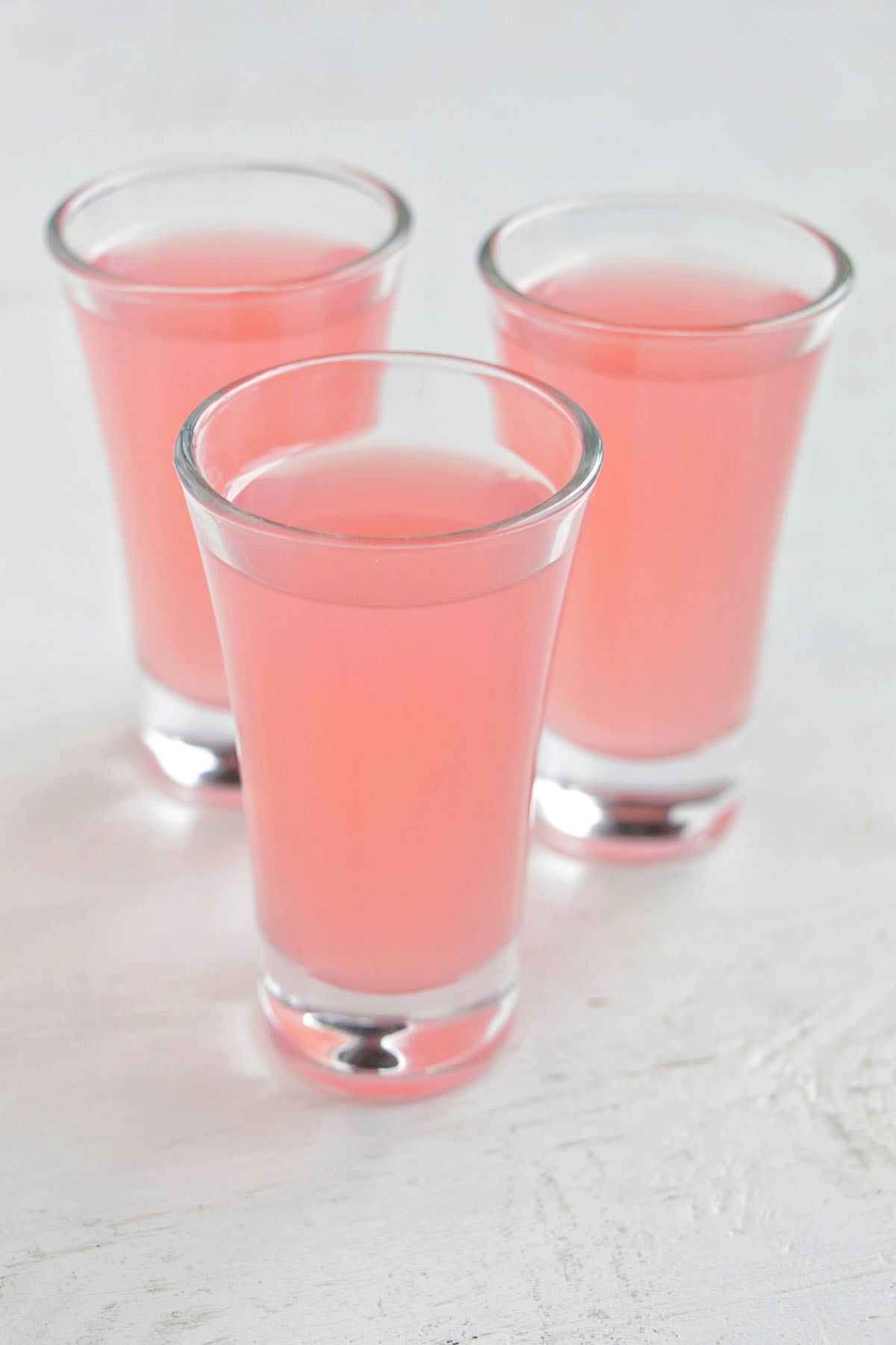 three pink raspberry lemonade shots.