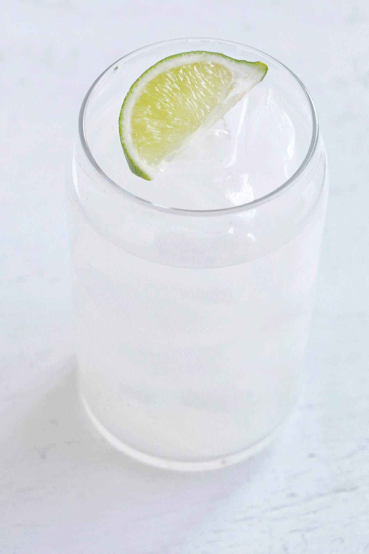 rum and coconut water drink with lime garnish.