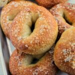 salt bagels on sheet tray.