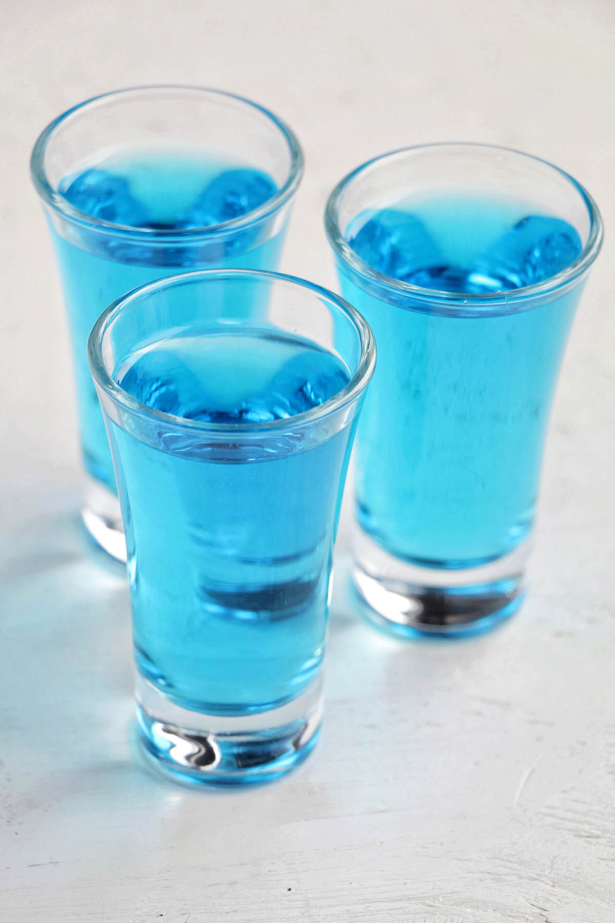 three blue sapphire martini shots.