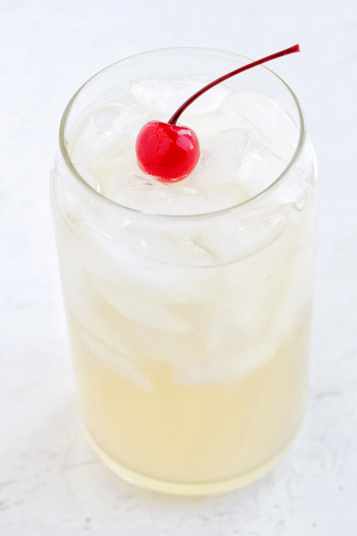 whiskey lemonade with cherry garnish.