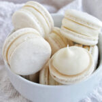 white macarons in a bowl.