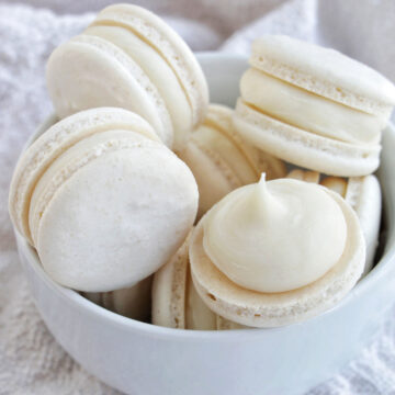 white macarons in a bowl.