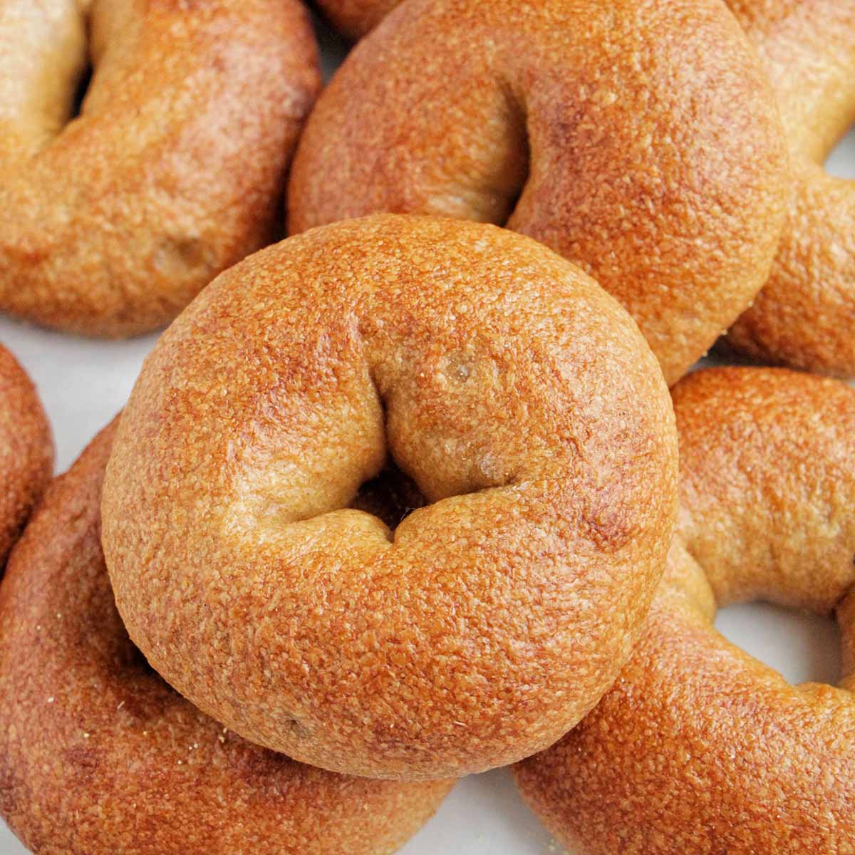 whole wheat bagels on sheet tray.