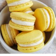 lemon macarons in a bowl with text overlay.