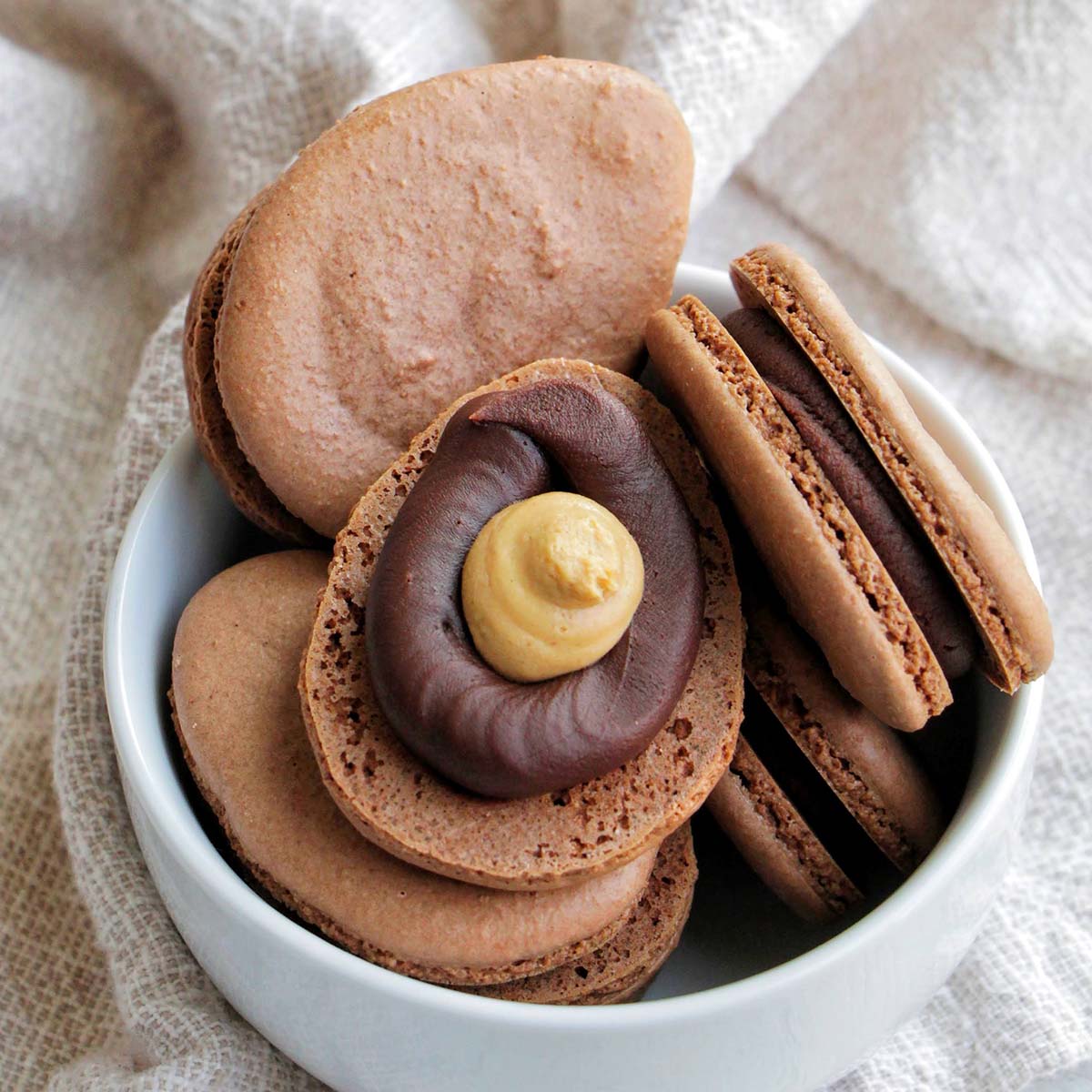 chocolate Reese's egg macarons in a bowl.