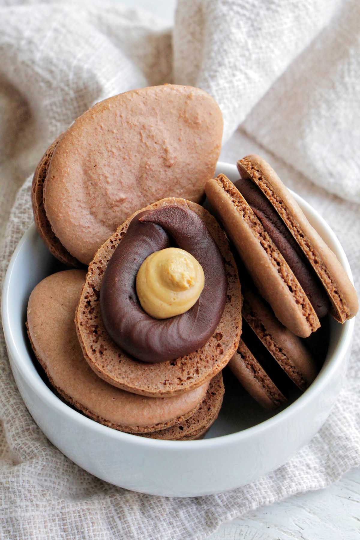 chocolate Reese's egg macarons in a bowl.