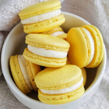 lemon buttercream macarons in a bowl.
