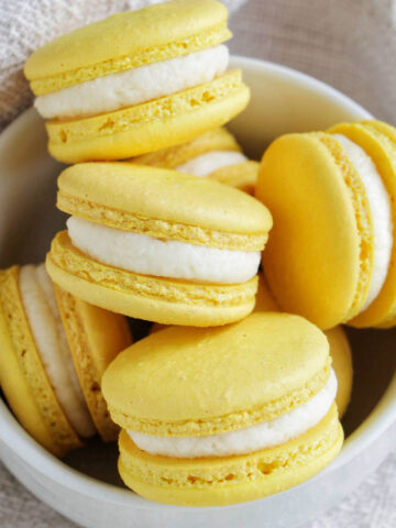 lemon buttercream macarons in a bowl.