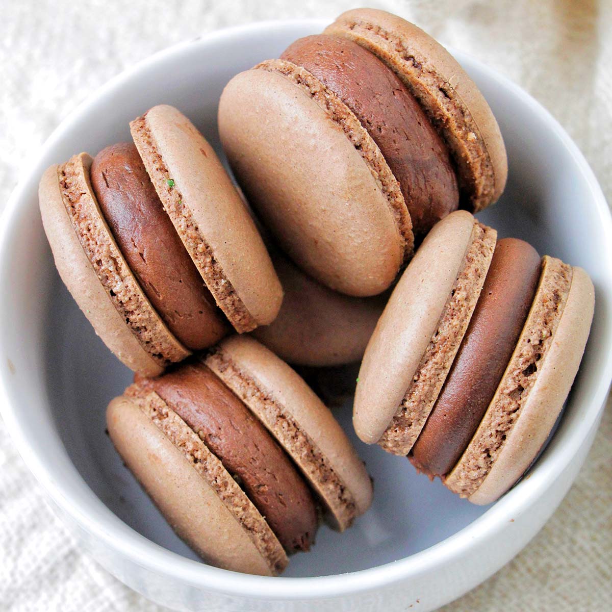 chocolate mint brownie macarons in a bowl.
