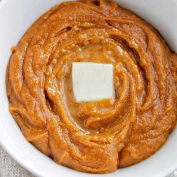 brown butter mashed sweet potatoes garnished with butter.