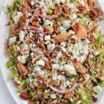 brussel sprout salad on white serving tray.