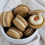 caramel cheesecake macarons in a bowl.