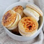 crème brulee macarons in a bowl.
