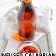 red Calabrian chili oil in a glass bottle with text overlay.