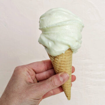 hand holding a cone with fior di latte gelato.