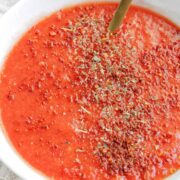 spicy pizza sauce in bowl with text overlay.