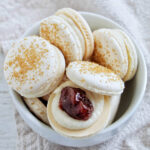 strawberry shortcake macarons in a bowl.