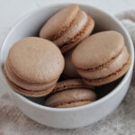 Nutella macarons in a bowl.