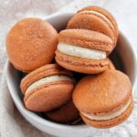 churro macarons in a bowl.