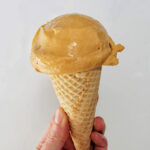 hand holing a cone with chocolate gelato.