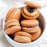 peanut butter and jelly macarons in a bowl.