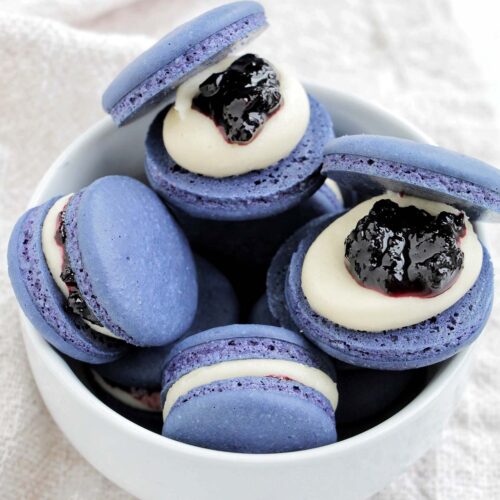 blueberry macarons in a bowl.