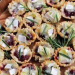 cranberry brie phyllo cups topped with rosemary.