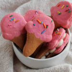 ice cream cone shaped macarons in a bowl.
