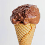 hand holing a cone with chocolate gelato.