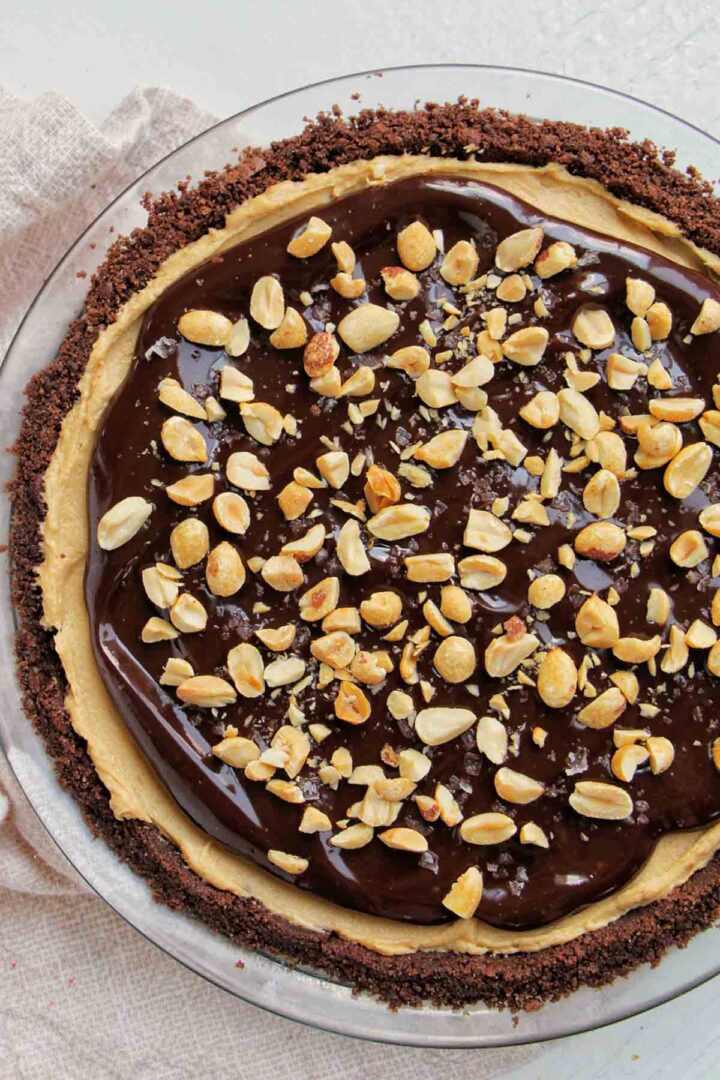 chocolate and peanut butter pie topped with peanuts.