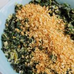 bowl of creamed kale topped with panko bread crumbs.