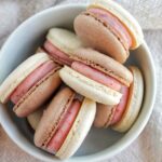 Neapolitan macarons in a bowl.