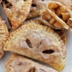 glazed apple hand pies on sheet tray.