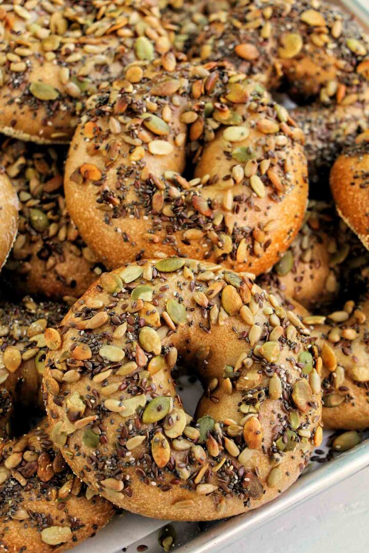 seeded bagels on a tray.
