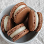 cream cheese brown butter macarons in a bowl.