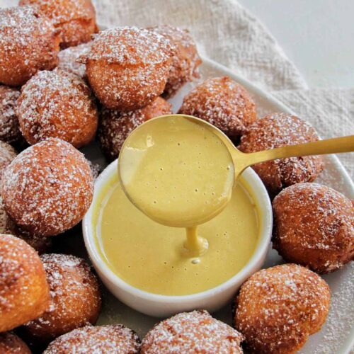 pistachio crème anglaise dipping sauce next to fried ricotta donuts.