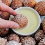 dipping donuts into vanilla crème anglaise sauce.