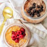 two bowls with chocolate protein overnight oats and toppings.