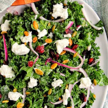 kale salad topped with goat cheese, onions, and pepitas.