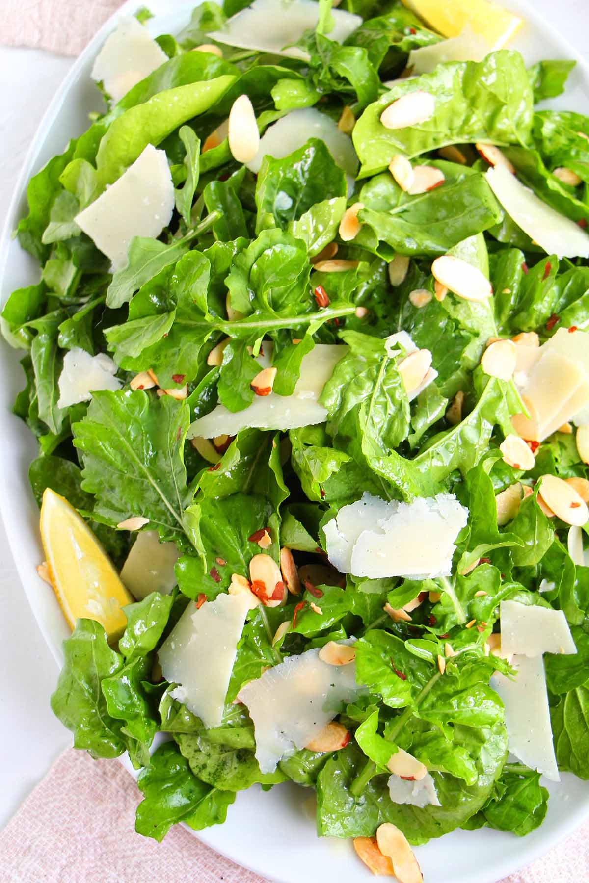 lemon and parmesan arugula salad on serving platter.