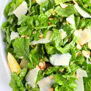 lemon and parmesan arugula salad on serving platter.