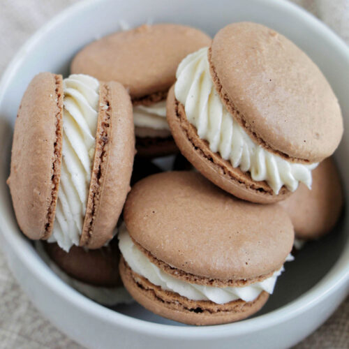 vanilla buttercream macarons in a bowl.