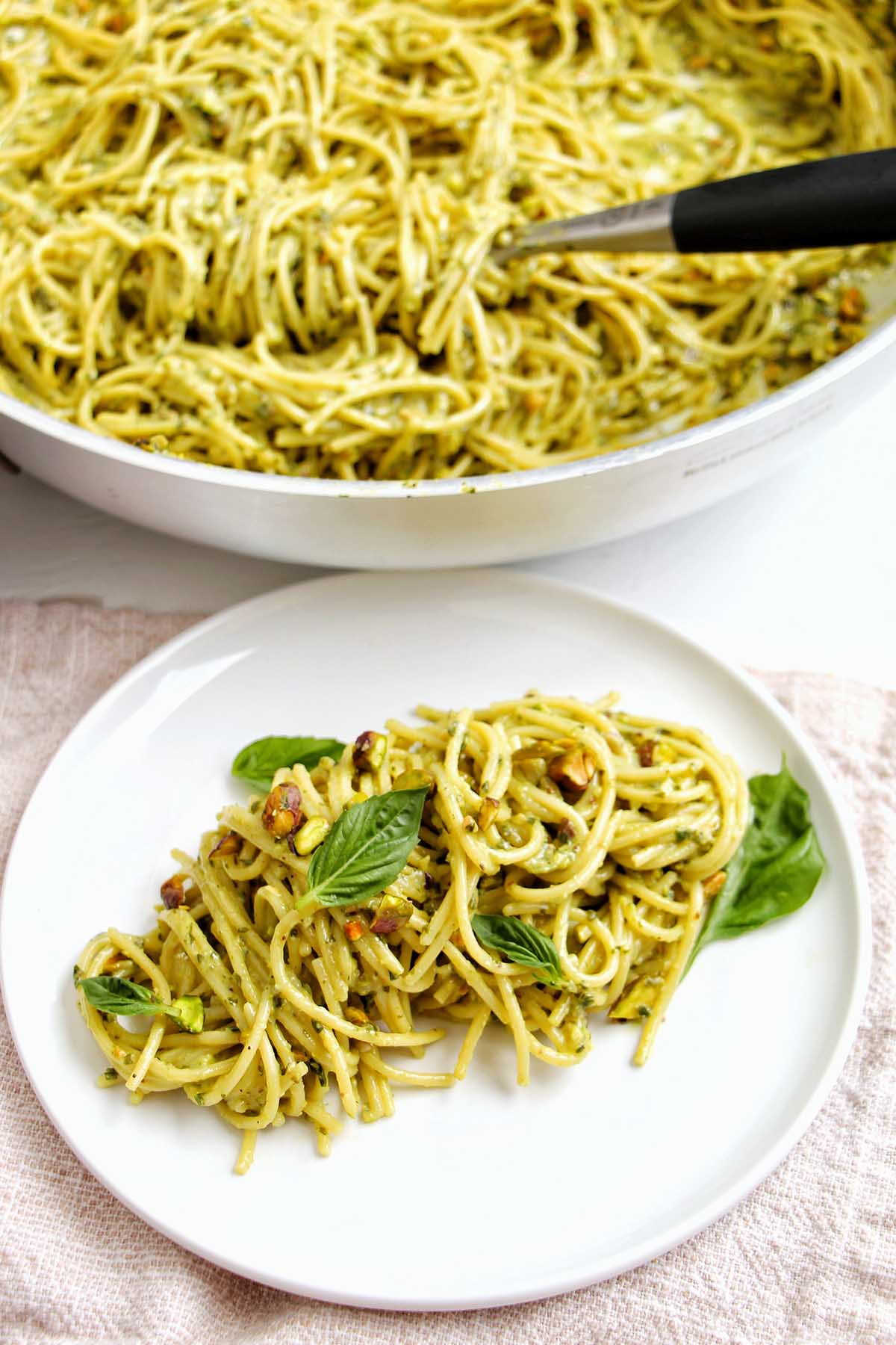 plate of pistachio pesto pasta with basil garnish.