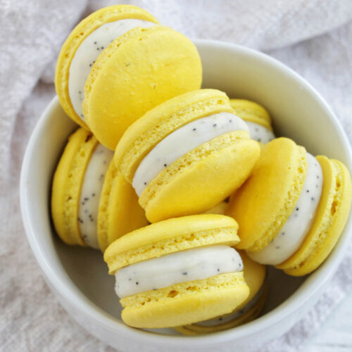 lemon poppy seed ganache macarons in a bowl.